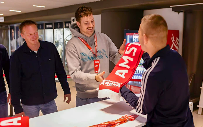Visitors receiving a scarf during a VIP tour at Johan Cruijff ArenA, Amsterdam.