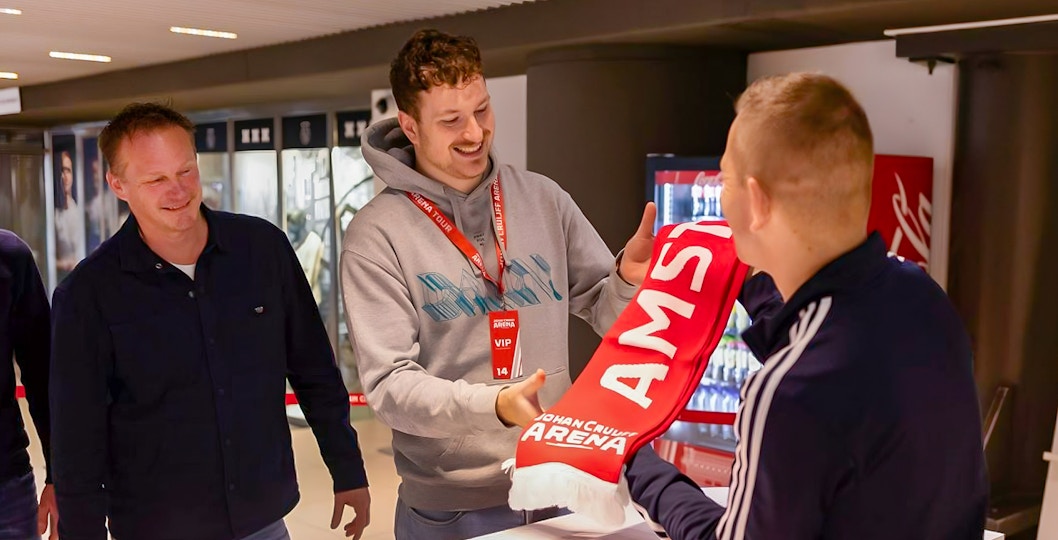 Visitors receiving a scarf during a VIP tour at Johan Cruijff ArenA, Amsterdam.