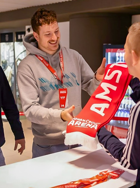 Visitors receiving a scarf during a VIP tour at Johan Cruijff ArenA, Amsterdam.