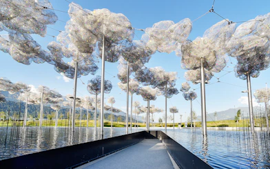 Swarovski Crystal Worlds outdoor installation with reflective water and mountain backdrop.