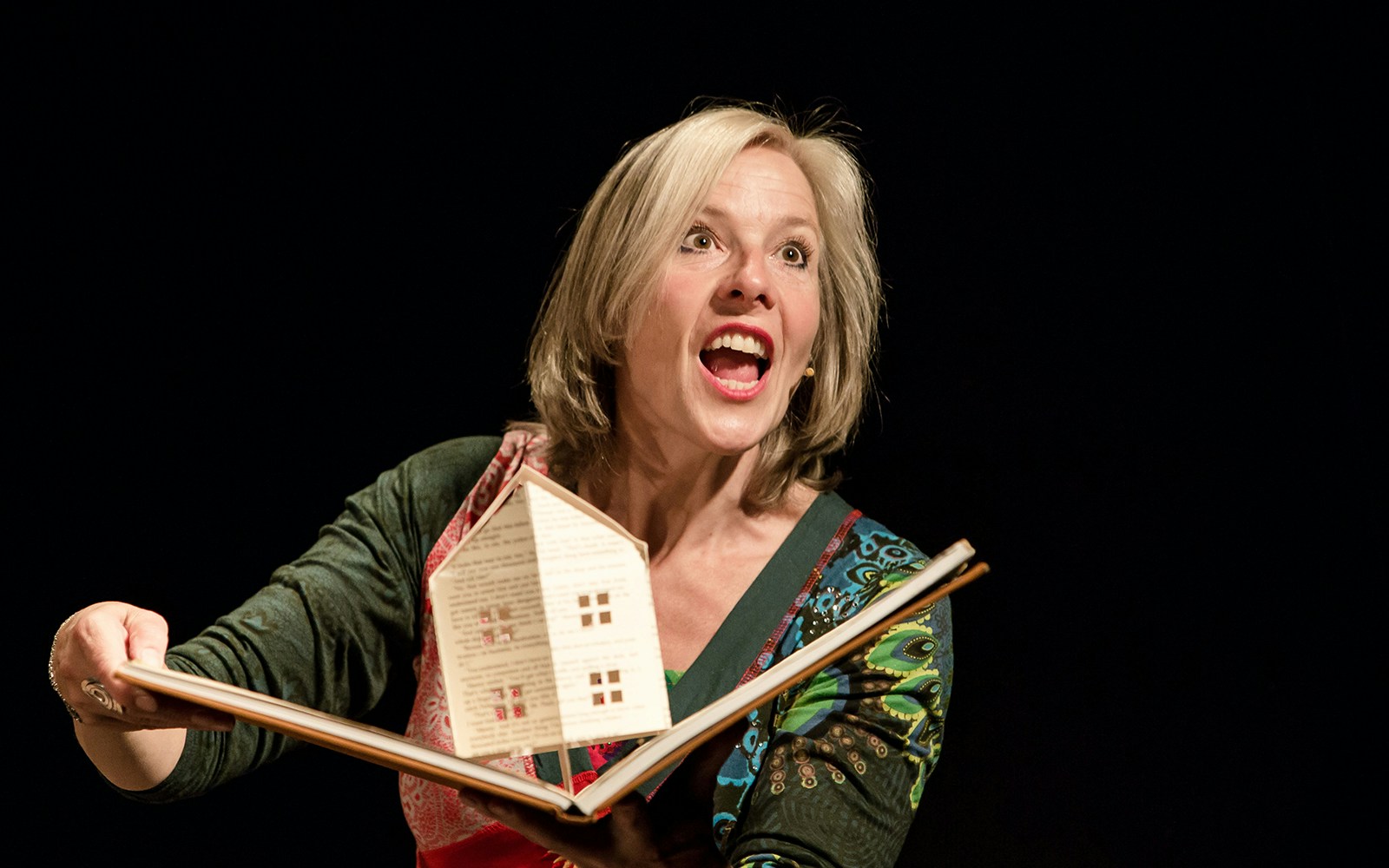 Storyteller performing "I Believe In Unicorns" with a pop-up book.