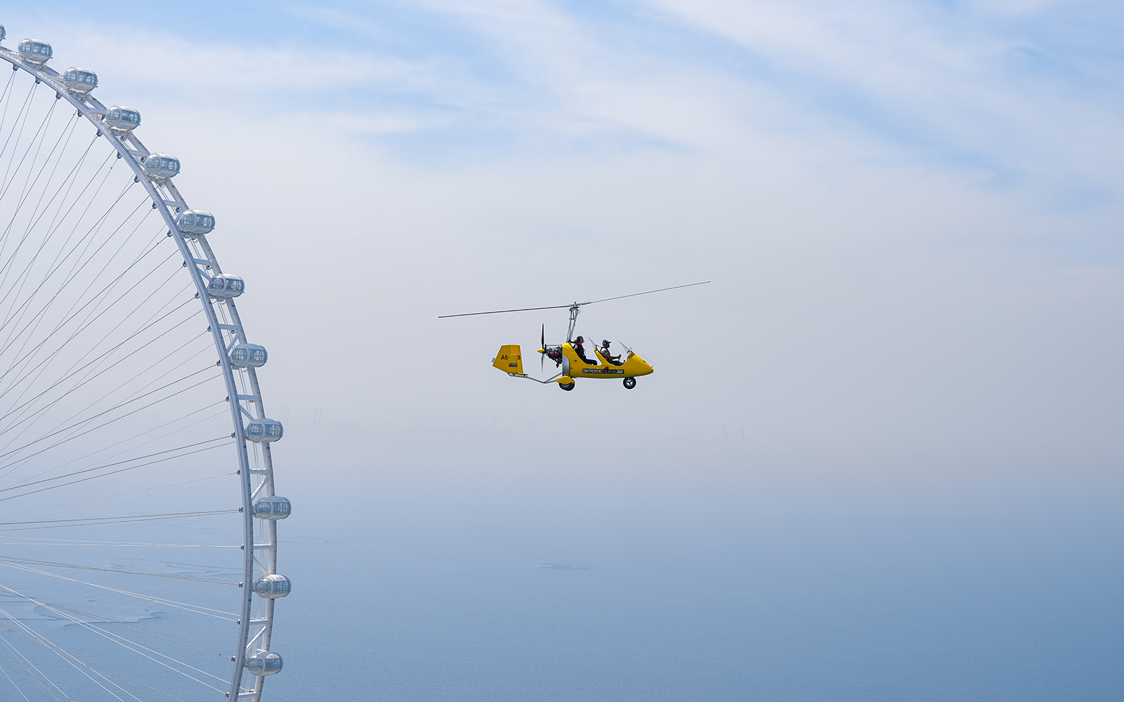 Gyrocopter flying near Ain Dubai at Skydive Dubai Palm Drop Zone.