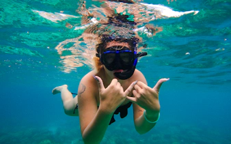 Snorkeler underwater in clear blue waters near Phi Phi Islands, Krabi.