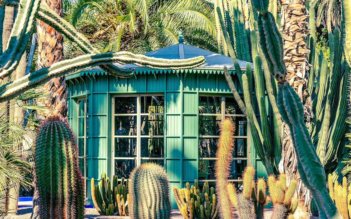Green pavilion surrounded by cacti at Jardin Majorelle, Marrakech.