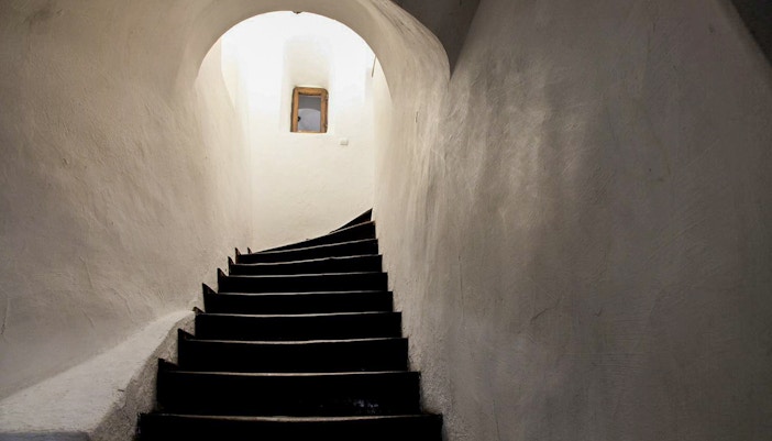 Curved staircase leading to a secret passageway inside Bran Castle, Transylvania, Romania.