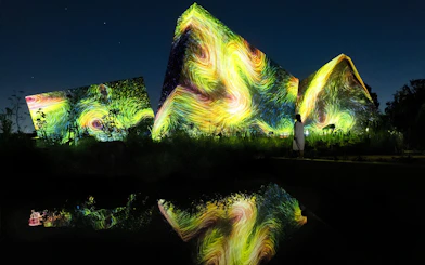 Visitors at teamLab Botanical Garden in Osaka viewing digital art installations.