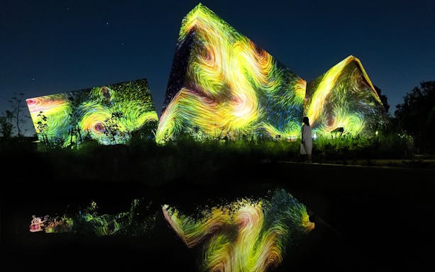 Visitors at teamLab Botanical Garden in Osaka viewing digital art installations.
