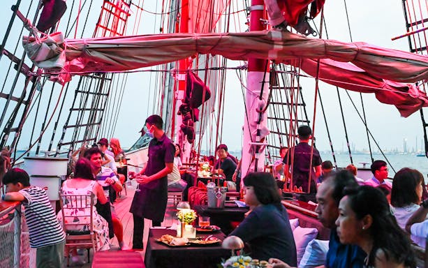Luxury tall ship cruising Singapore waters with international cuisine menu.