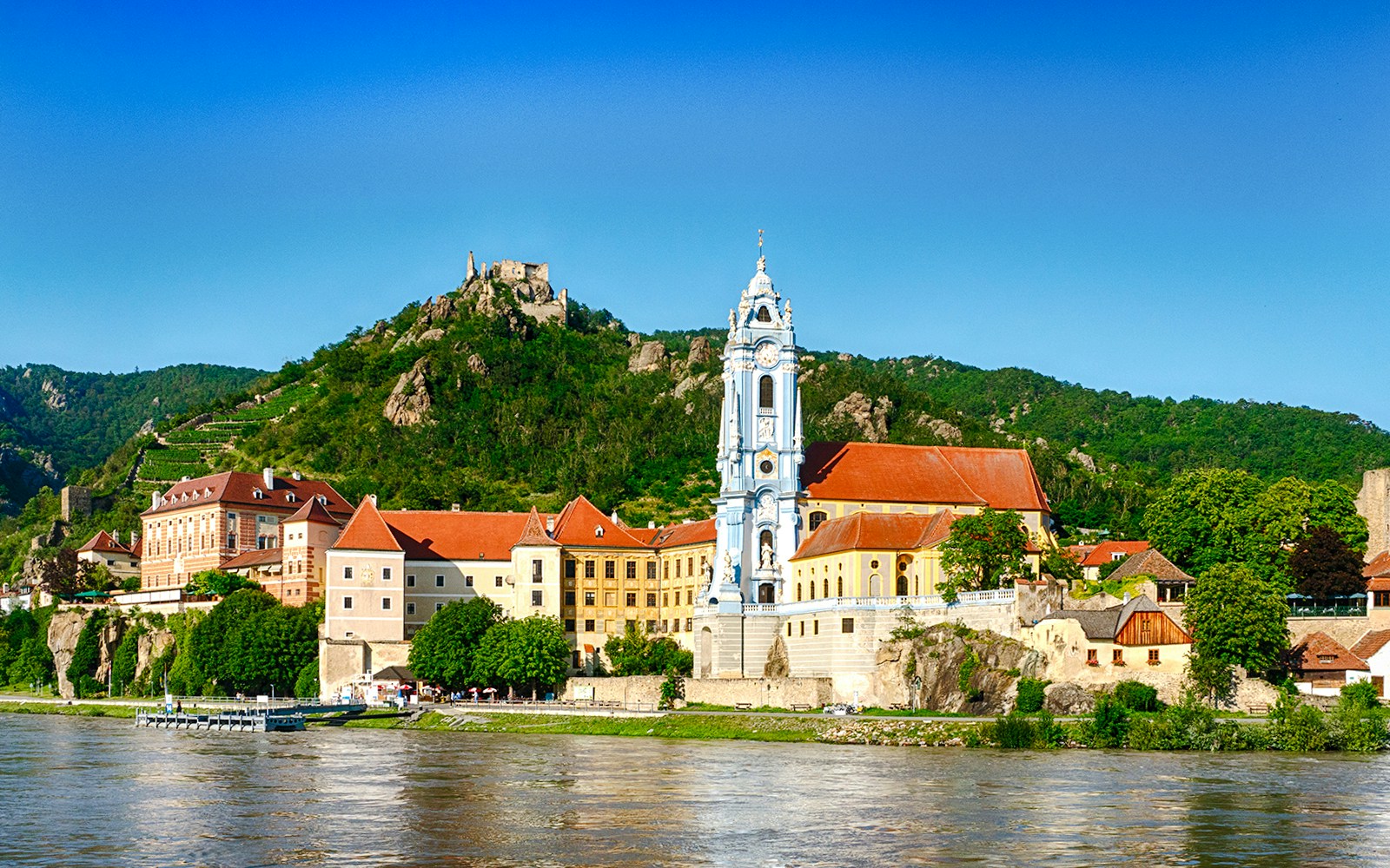 Dürnstein village with blue church tower and Danube River, Wachau Valley, Austria.