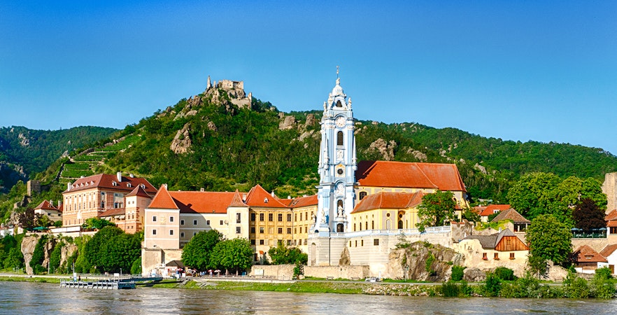 Dürnstein village with blue church tower and Danube River, Wachau Valley, Austria.