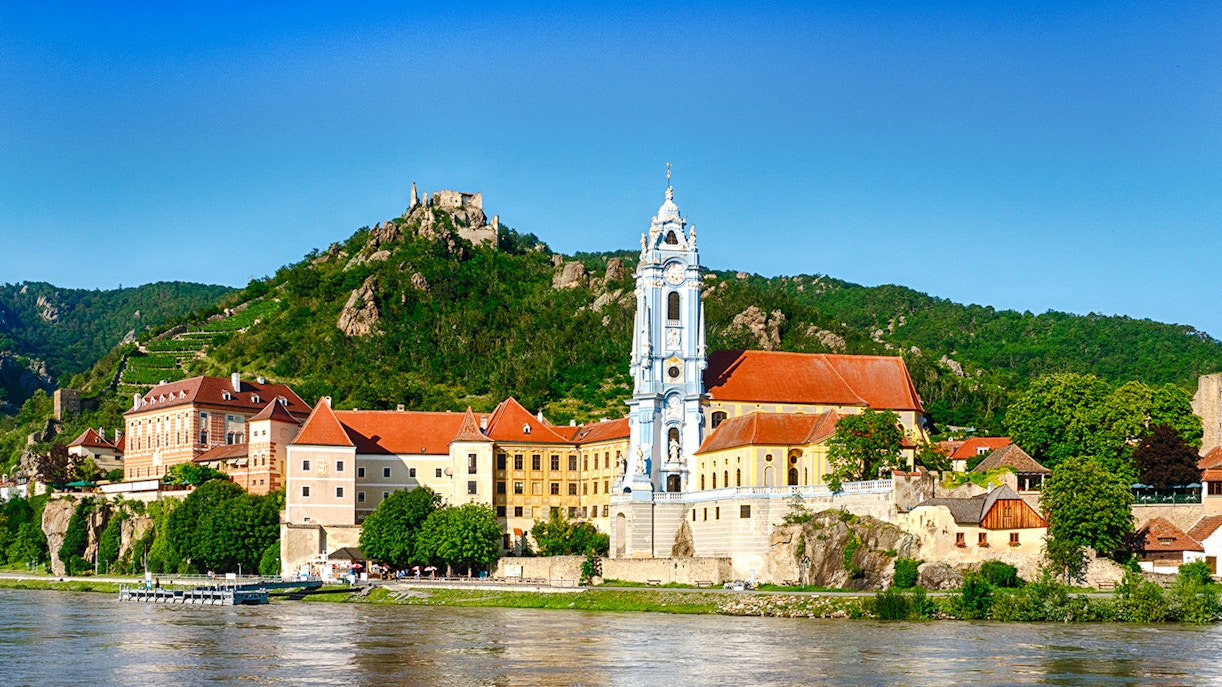 Dürnstein village with blue church tower and Danube River, Wachau Valley, Austria.