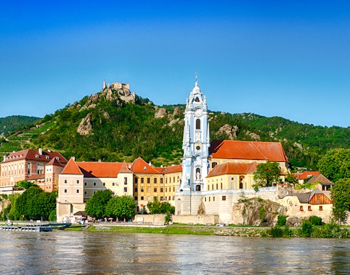 Dürnstein village with blue church tower and Danube River, Wachau Valley, Austria.