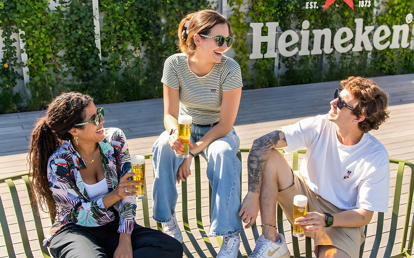 Tourists exploring interactive exhibits at Heineken Experience, Amsterdam.