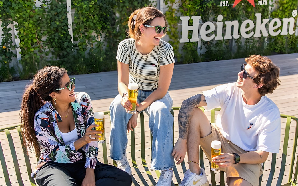 Tourists exploring interactive exhibits at Heineken Experience, Amsterdam.