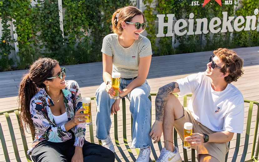 Tourists exploring interactive exhibits at Heineken Experience, Amsterdam.