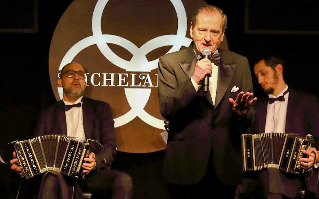 Singer performing with musicians at Michelangelo Tango Show.