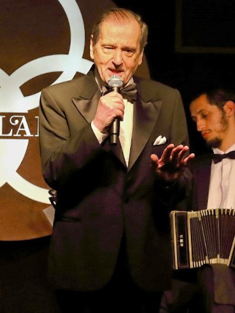 Singer performing with musicians at Michelangelo Tango Show.