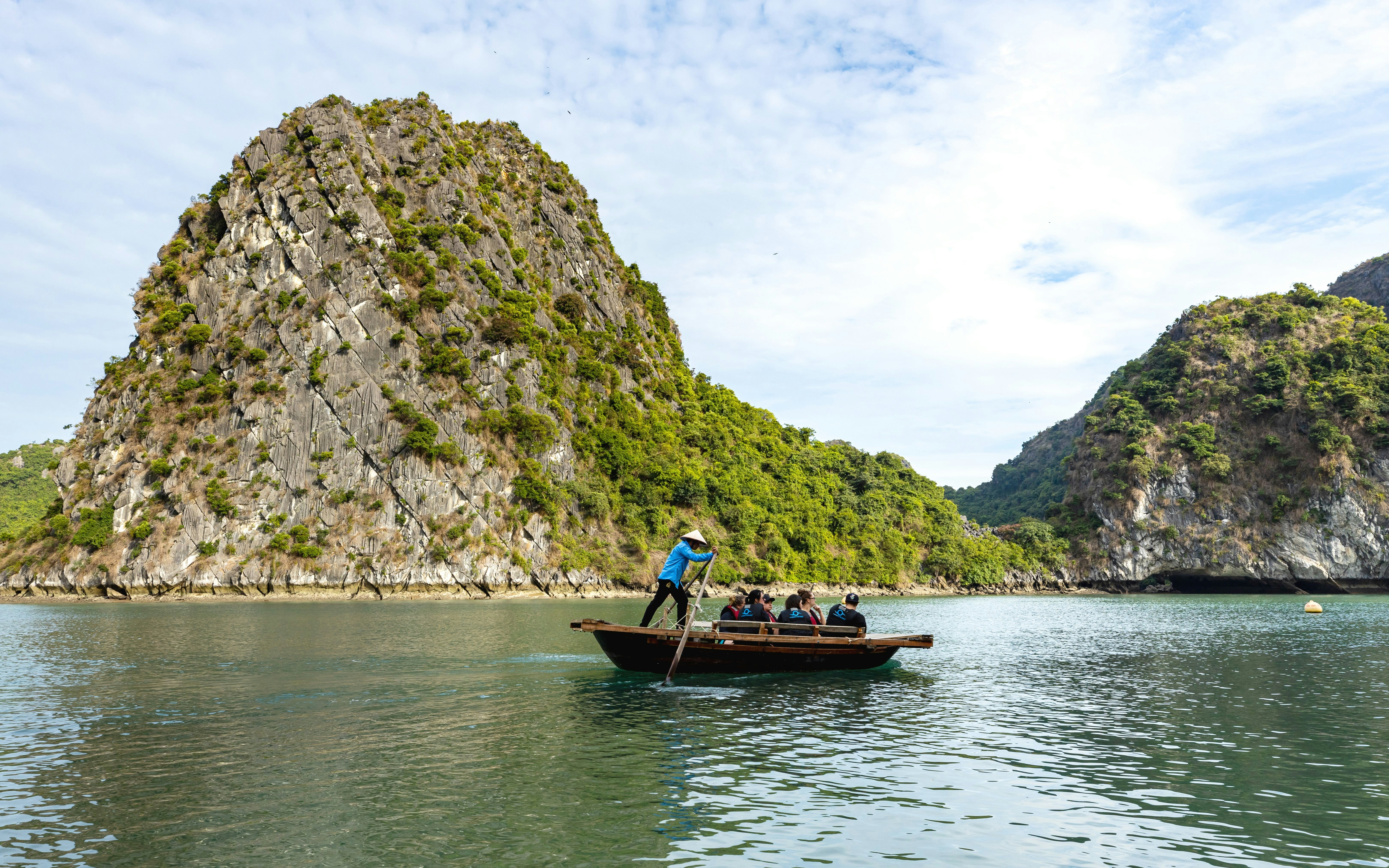 Tourists on a boat near Luon Cave, Halong Bay, Vietnam.