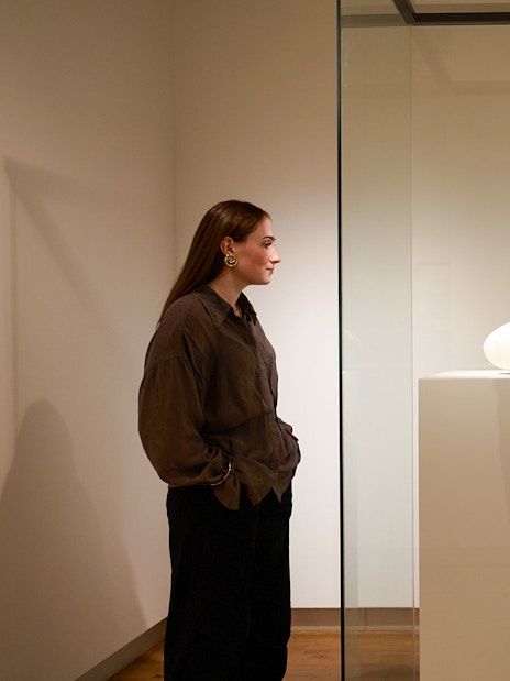 Exhibit of a white sculpture inside the H’ART Museum display case.