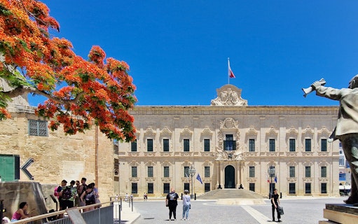 Valletta walking tour with tourists near Auberge de Castille, Malta.