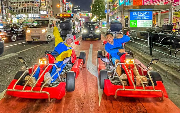 Go-kart riders in costumes driving through Shibuya at night, Tokyo Go Kart and Photoshooting Experience.