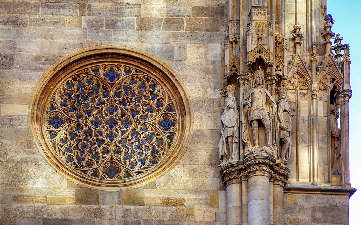 St. Stephen's Cathedral Vienna, intricate rose window and detailed stone statues.