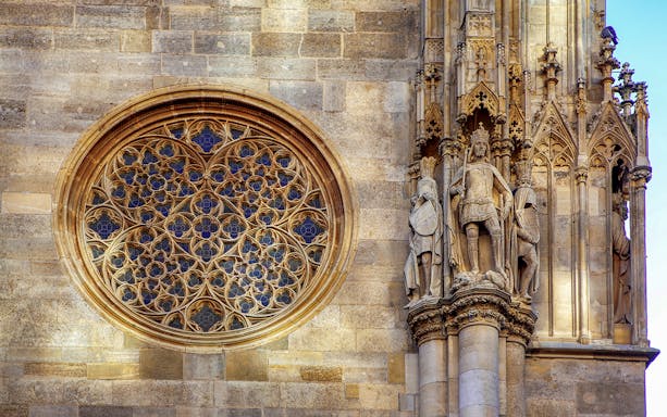 St. Stephen's Cathedral Vienna, intricate rose window and detailed stone statues.