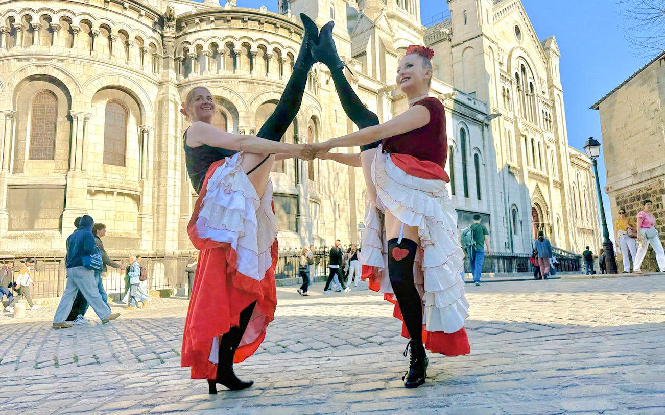Cancun performers in traditional attire dancing on stage in Paris, France.