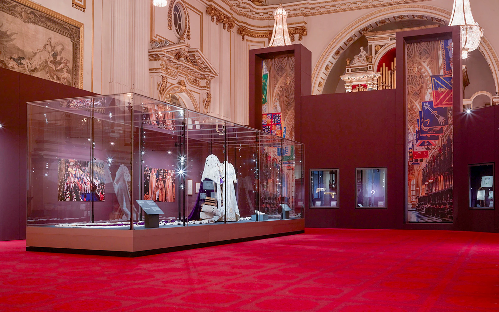 Coronation display in the Ballroom of Buckingham Palace featuring royal garments and historical exhibits.