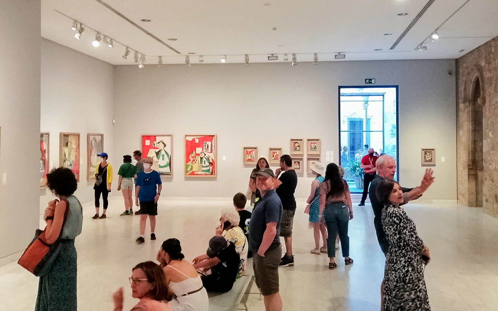 Visitors viewing artwork in a gallery at the Picasso Museum, Barcelona.