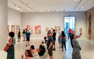 Visitors viewing artwork in a gallery at the Picasso Museum, Barcelona.