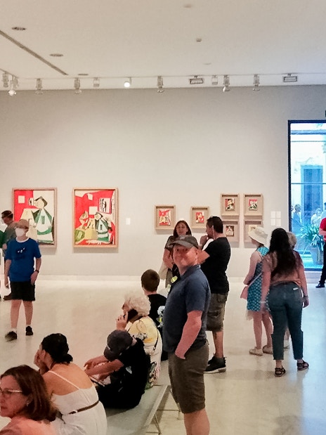 Visitors viewing artwork in a gallery at the Picasso Museum, Barcelona.