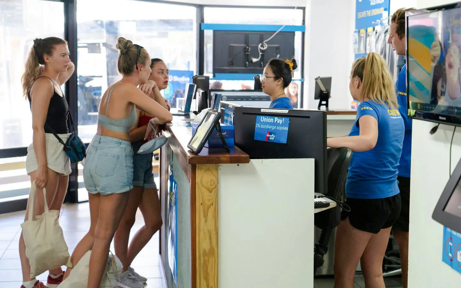 Customers at a check-in desk for tandem skydive at Mission Beach.