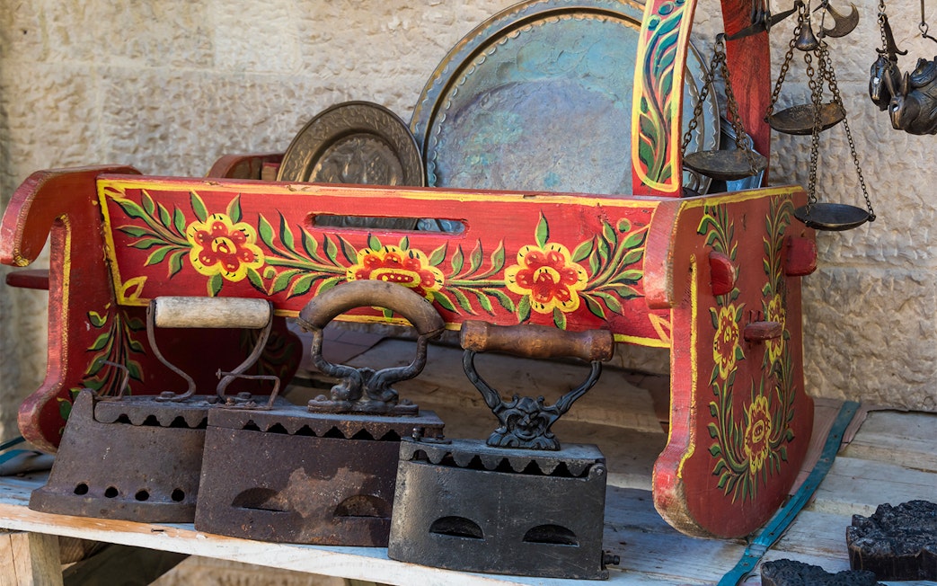 Antique irons and painted wooden box at Kruje Albania Old Market.