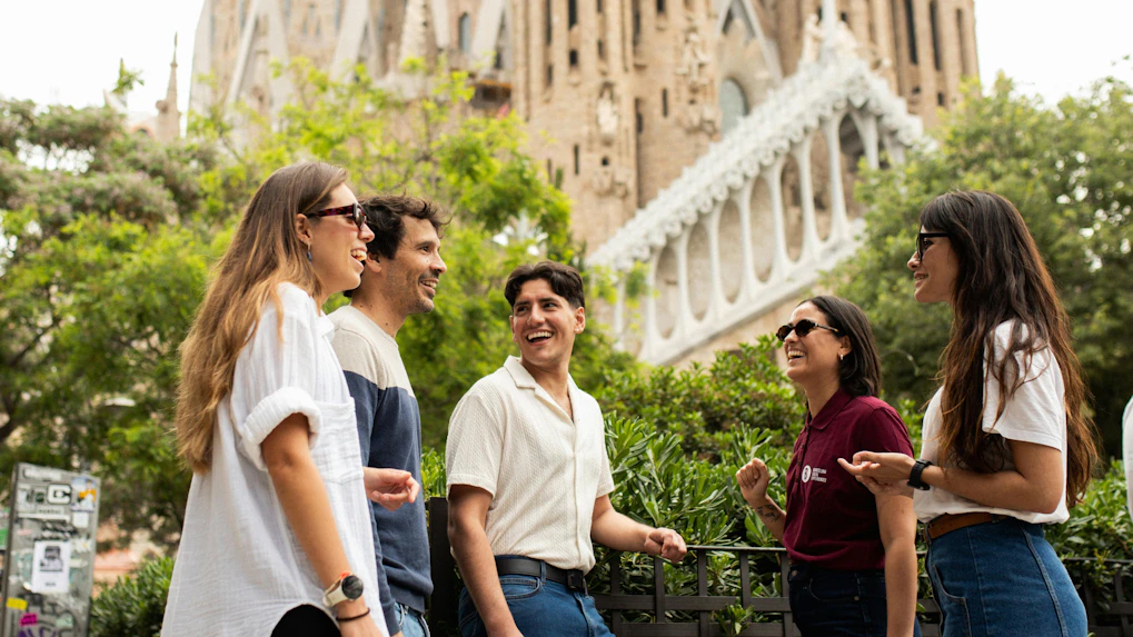 Tourists with guide at Sagrada Familia, Barcelona, enjoying a group discussion.