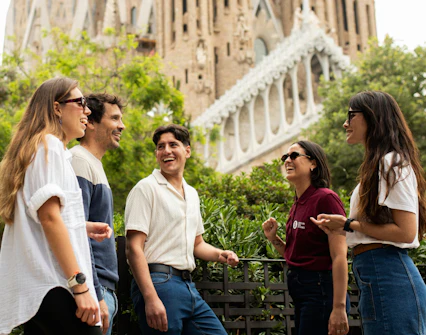Tourists with guide at Sagrada Familia, Barcelona, enjoying a group discussion.