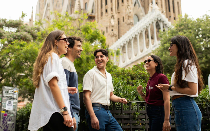 Tourists with guide at Sagrada Familia, Barcelona, enjoying a group discussion.