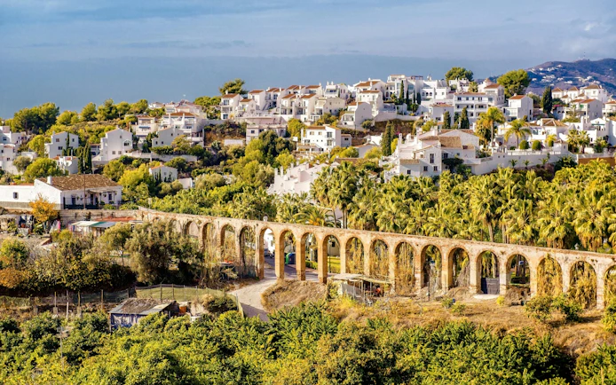 Nerja landscape with historic aqueduct and white houses, Province of Malaga, southern Spain.