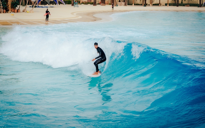 Surfer riding a wave at Surftopia, Saudi Arabia.
