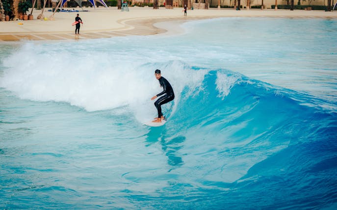 Surfer riding a wave at Surftopia, Saudi Arabia.