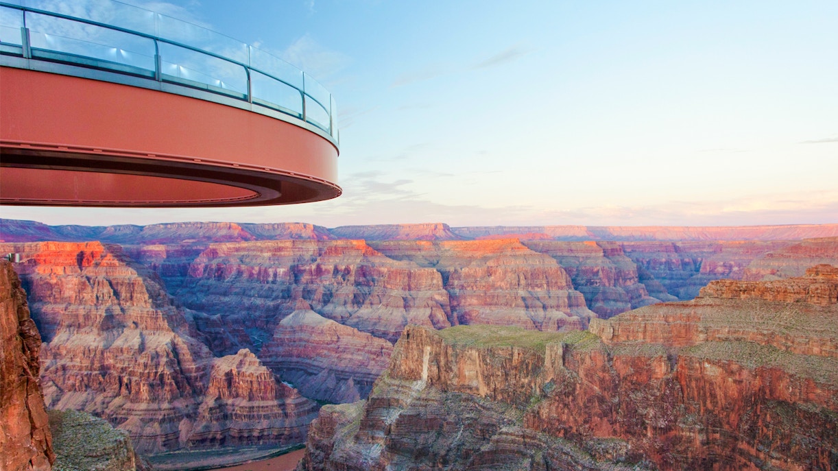 Grand Canyon Skywalk overlooking canyon at sunset, part of Las Vegas helicopter tour.