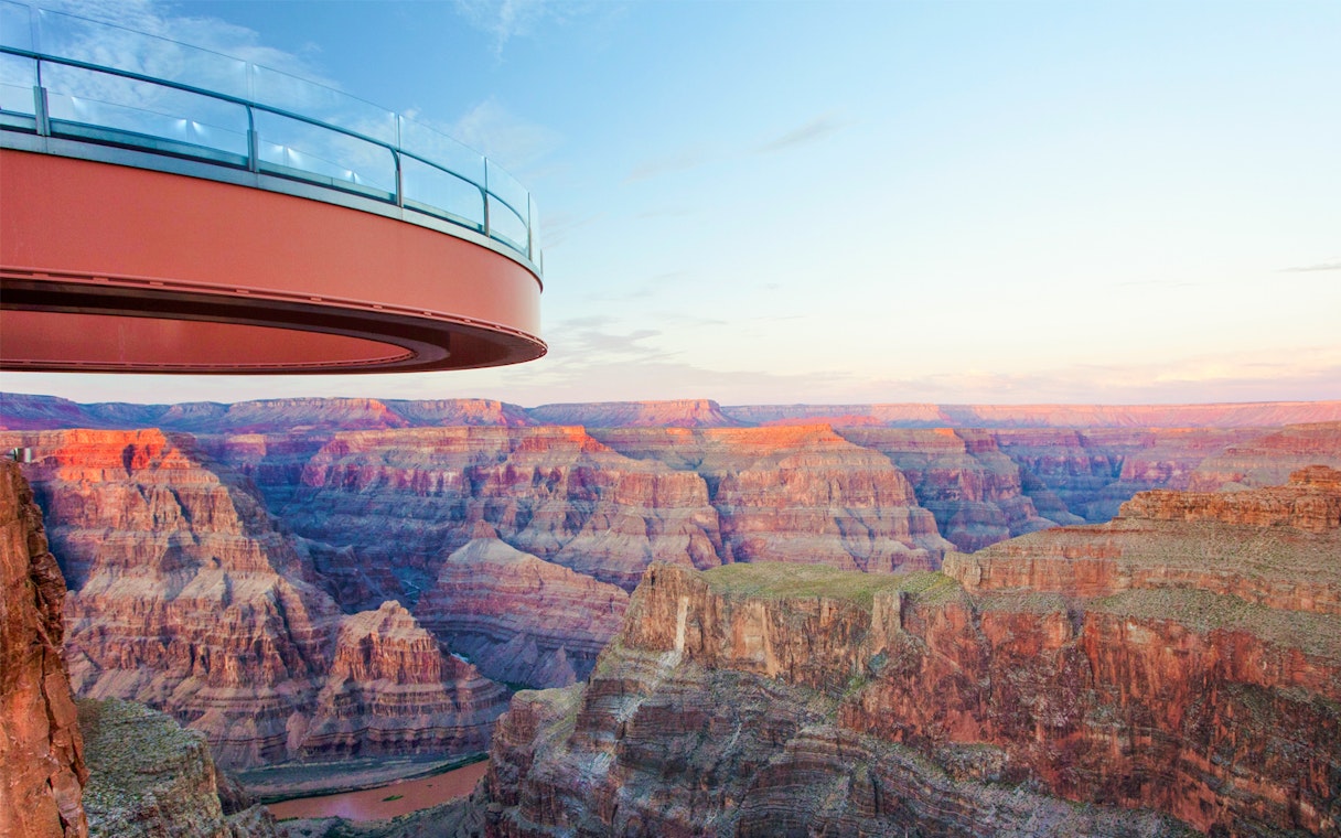 Grand Canyon Skywalk overlooking canyon at sunset, part of Las Vegas helicopter tour.