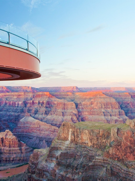 Grand Canyon Skywalk overlooking canyon at sunset, part of Las Vegas helicopter tour.