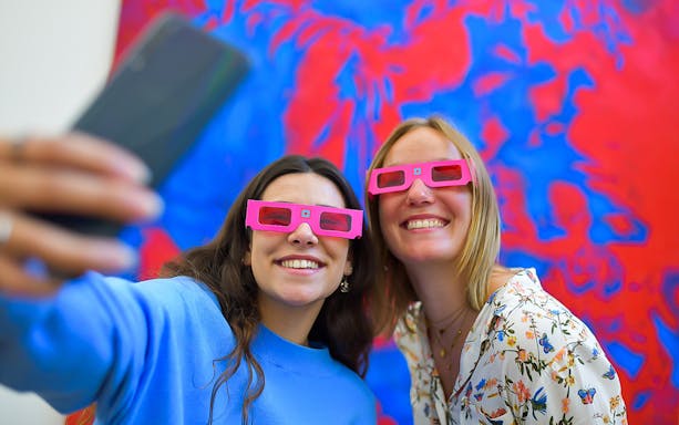Visitors wearing 3D glasses at Illusion Art Museum in Prague.