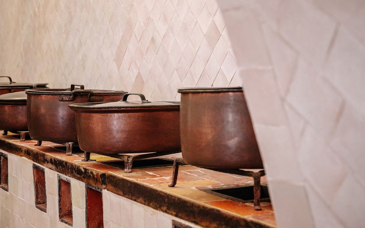 Copper pots in the historic kitchen of Sintra National Palace, Portugal.
