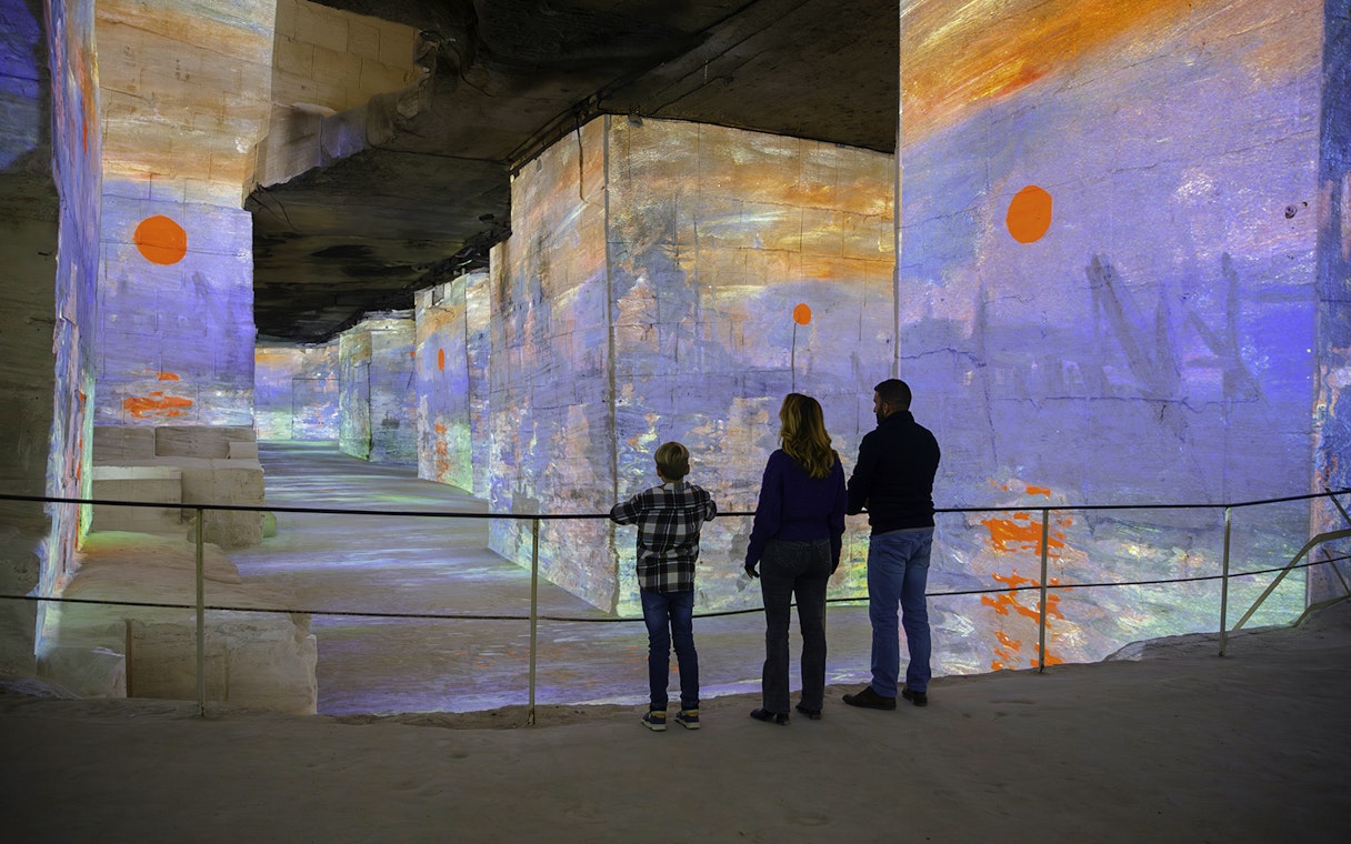 Visitors viewing Monet projections at Carrières des Lumières, Les Baux-de-Provence.