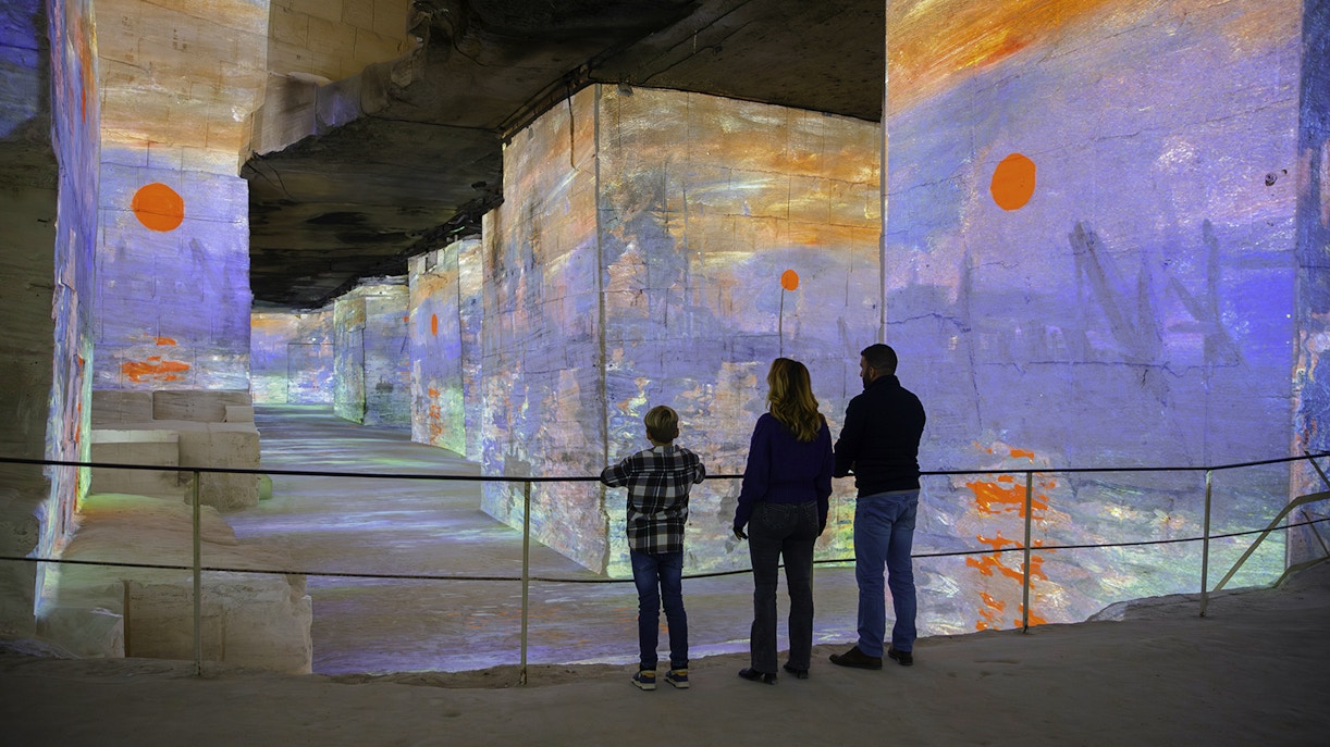 Visitors viewing Monet projections at Carrières des Lumières, Les Baux-de-Provence.