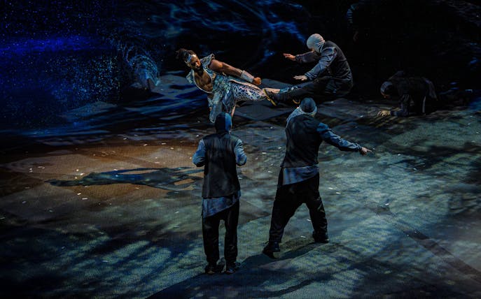 Acrobatic performance scene from La Perle show in Dubai, featuring dynamic martial arts.