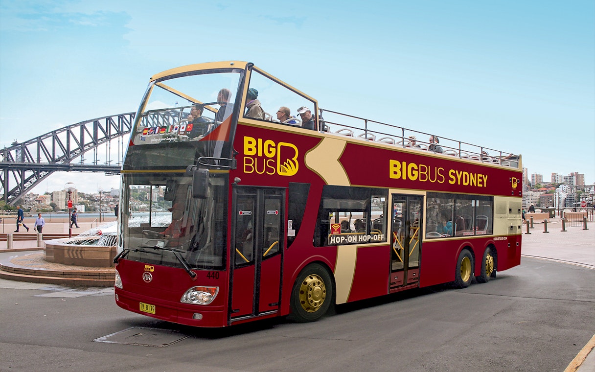 Open-top Big Bus Sydney near Sydney Harbour Bridge, part of Sydney Explorer Pass by Go City.