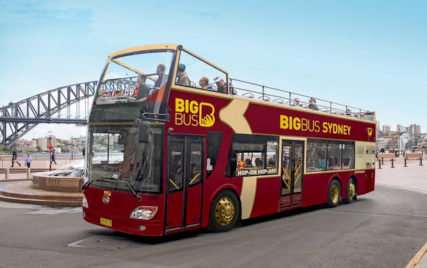 Open-top Big Bus Sydney near Sydney Harbour Bridge, part of Sydney Explorer Pass by Go City.